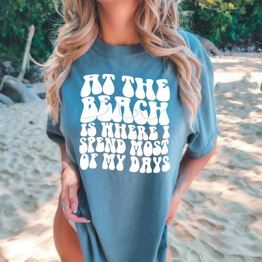 AT THE BEACH IS WHERE I SPEND MOST OF MY DAYS GRAPHIC TEE